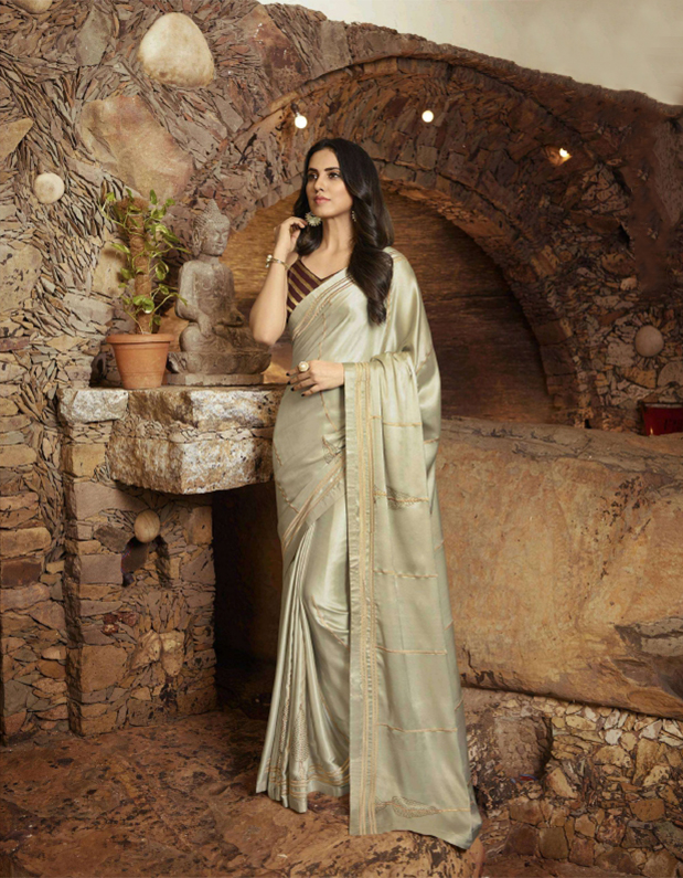 Beige satin georgette designer saree has a golden zari embroidery work with jacquard blouse that you can wear for any occasion without any discomfort. It is suitable for both hand wash and  machine wash.