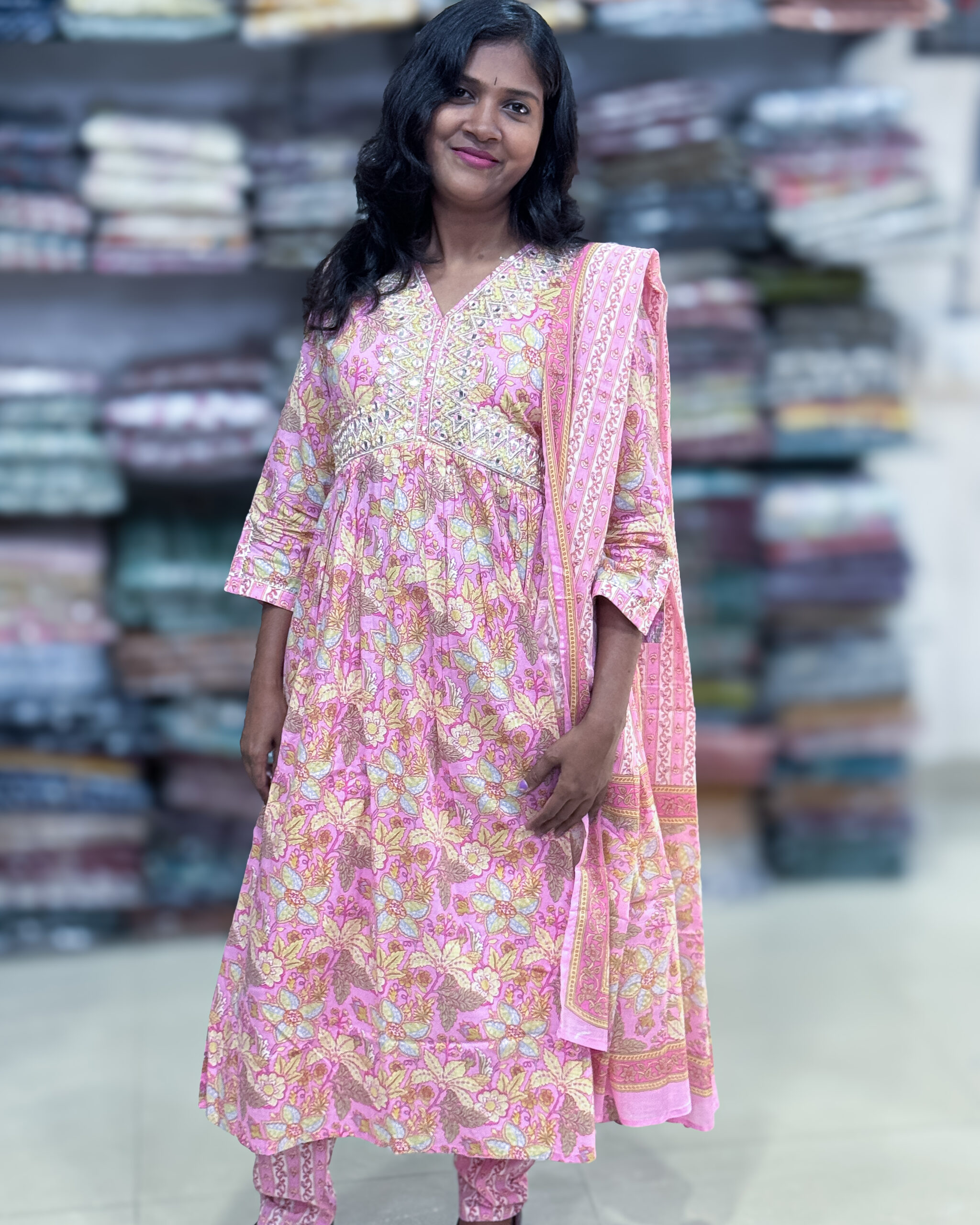 Beautiful mul cotton suit has sequins on the yoke with pleated neckline comes with an elastic waist pant and dupatta. This will be a perfect choice for any occasion.It is suitable for both hand wash and machine wash.