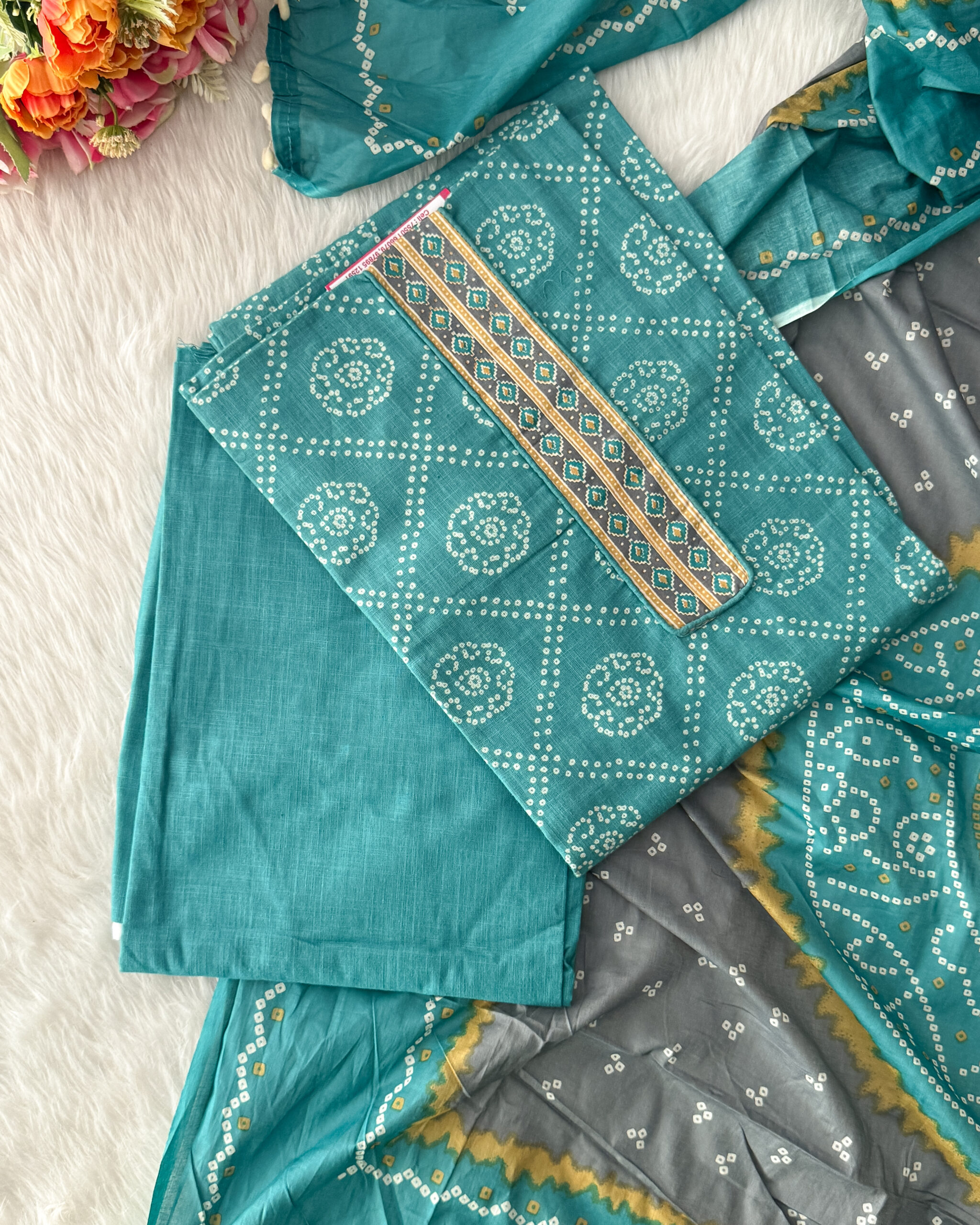 Pure cotton bandhani printed material with neck pattern comes with plain bottom and printed dupatta with pompom. It is suitable for both hand wash and machine wash.