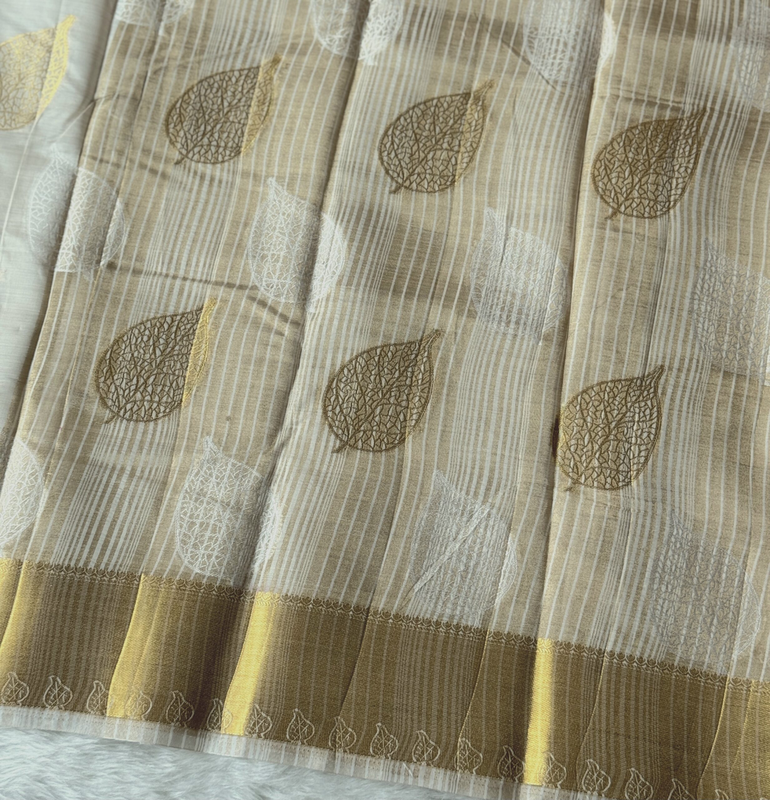 Beautiful tussar cotton saree with leaf design and golden zari border with running blouse.
